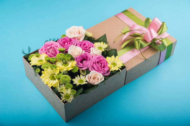 beautiful gift box with flowers. wedding decoration accessory. blue background - 写真・画像