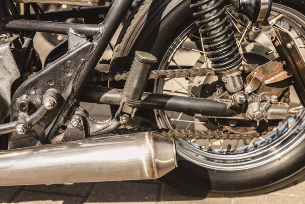 Close up detail of a powerful vintage motorcycle - rear suspension and drive wheel - Foto, Imagem