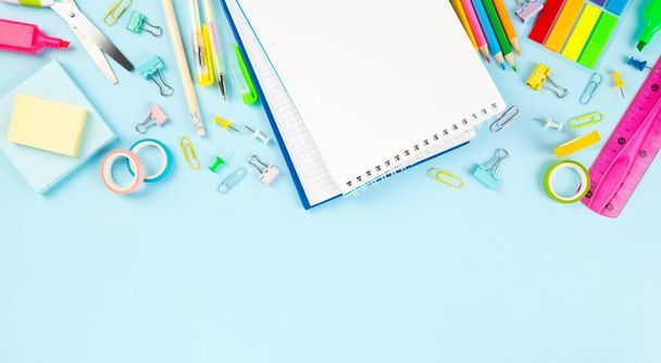 Various school office supplies on blue background. Back to school concept. Top view. Copy space - Zdjęcie, obraz