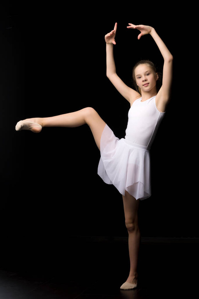 Full length portrait of a charming gymnast girl in elegant dress. - Foto, afbeelding