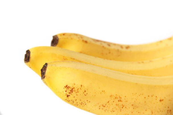 A bunch of bananas on a white background. Yellow tropical fruits. Ripe bananas - Foto, afbeelding