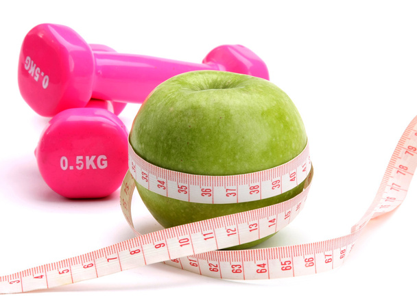 An apple, a measuring tape and dumbbell - Zdjęcie, obraz