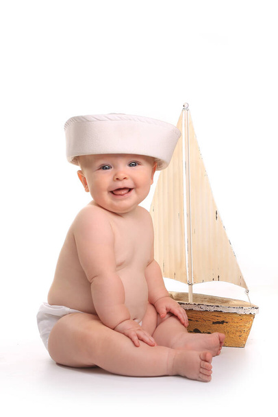 Happy Baby Toddler Sitting up Wearing Sailor Hat on White Background - Φωτογραφία, εικόνα