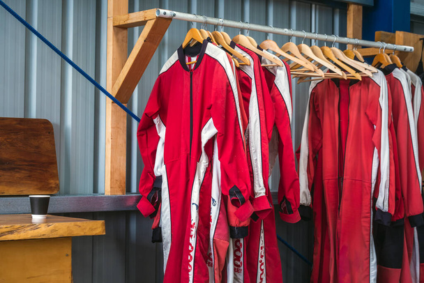 Skydivers suits on a hangers at Franz Josef Glacier, New Zealand. - Photo, Image