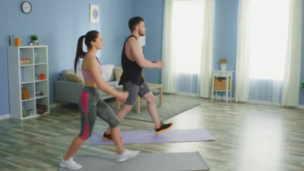 Active Couple Is Doing Forward Lunges at Home - Záběry, video