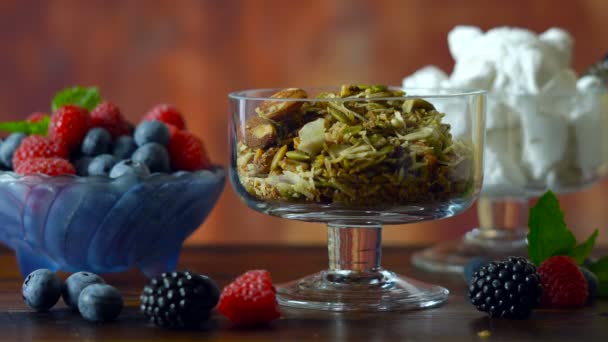 Grain free paleo granola breakfast serving with coconut milk and fresh fruit. - Video, Çekim