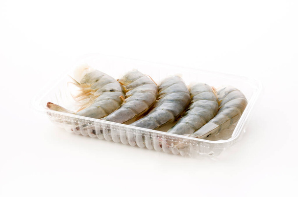 Fresh black tiger shrimp tails in plastic pack on white background - Photo, Image