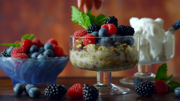 Grain free paleo granola breakfast serving with coconut milk and fresh fruit. - Filmati, video