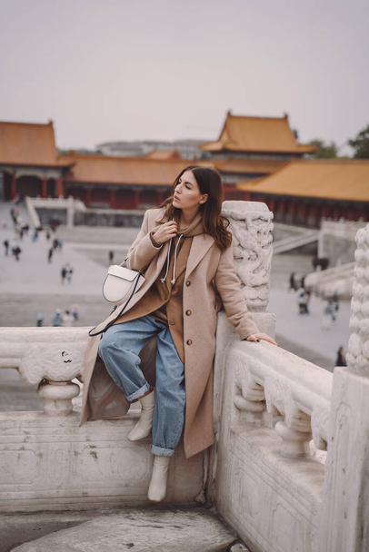 stylish girl visiting the forbidden city in Beijing China - Photo, Image