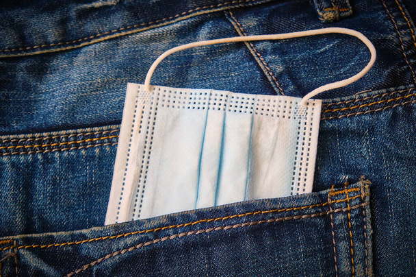 Surgical mask in back pocket. Hygiene concept. - Photo, Image