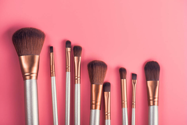 set cosmetic brush for beauty makeup on pink background - Foto, afbeelding