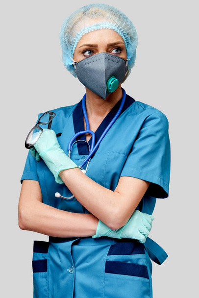 female doctor with stethoscope wearing protective mask and latex gloves over light grey background - Φωτογραφία, εικόνα