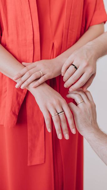 beautiful hand of a girl with a ring on her finger in a red dress - Foto, Imagem