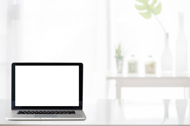Mockup portátil de pantalla en blanco en la mesa blanca, espacio de copia para la visualización del producto
. - Foto, imagen