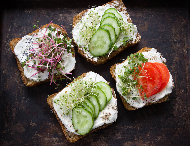 Здоровые сэндвичи со сливочным сыром, микрозеленью, помидорами и огурцом. Здоровое питание, диетическая еда, веганская еда, здоровый завтрак
 - Фото, изображение