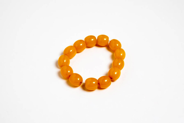 Amber material prayer beads (rosary) on white background.High-resolution photo. - 写真・画像