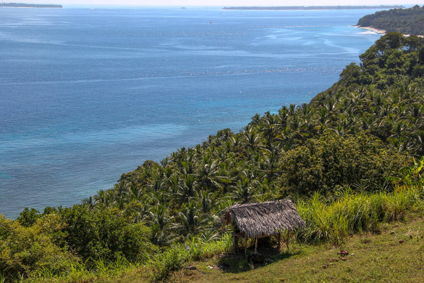 A traditional Indonesian hut on a hill with the view of Lombok Strait in Indonesia - Photo, Image