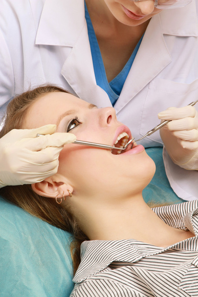Female dentist is treating teeth of the patient - Foto, Imagen