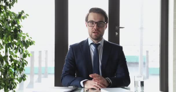 Confident businessman wearing suit speaking to camera broadcasting professional webinar - Metraje, vídeo