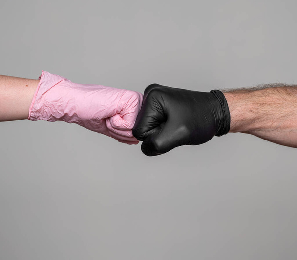 Healthcare concept. Handshake in protective medical gloves over gray background - Fotoğraf, Görsel