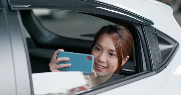 Woman uses phone to take photo in car - Photo, Image