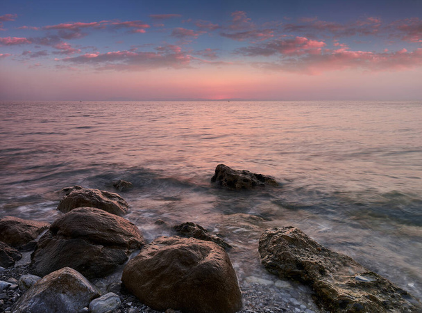 Amazing landscape of sunrise at sea. Colorful morning view of dramatic sky, seascape and rock. Long exposure image. Greece. Mediterranean Sea. Concept of nature background. - Photo, Image