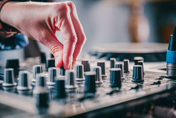 DJ Hands creating and regulating music on dj console mixer in concert nightclub stage. - Valokuva, kuva