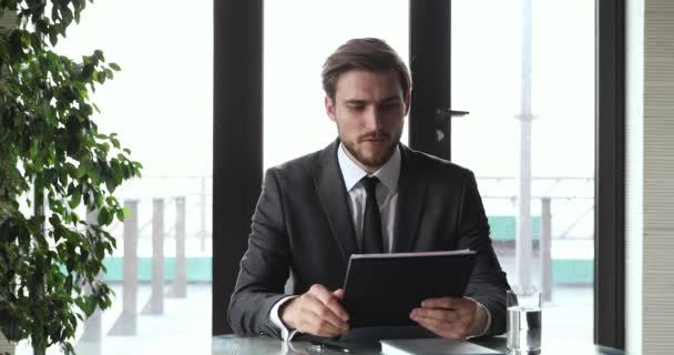 Young businessman wearing suit holding remote online webcam job interview - Video, Çekim
