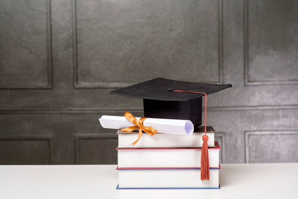 Graduation cap with books on white desk , Education background  - Fotó, kép