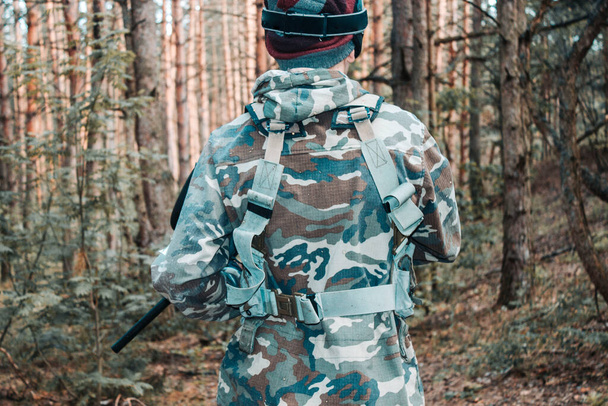 A young special forces soldier in camouflage on a combat mission in the forest - 写真・画像