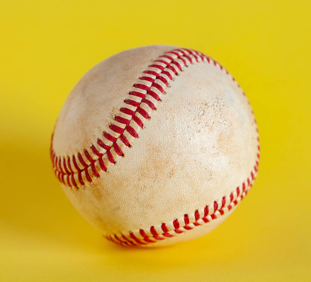 worn baseball isolated on yellow background, team sport. Object - Photo, Image