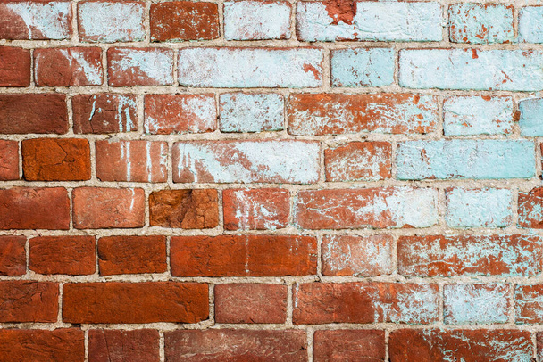 Old red brick wall painted with half light blue paint - Photo, Image