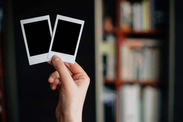 two polaroid shots in the hands of a girl - Fotoğraf, Görsel