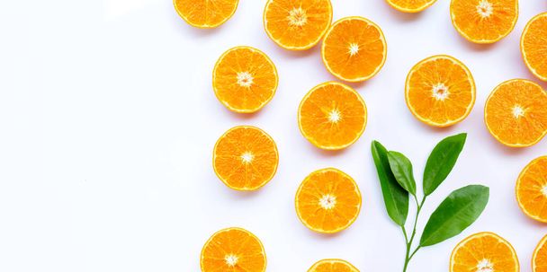 Orangefarbene Früchte mit Blättern auf weißem Hintergrund. Kopierraum - Foto, Bild
