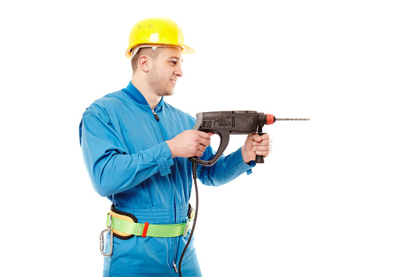 Trabajador con casco trabajando con un taladro
 - Foto, imagen
