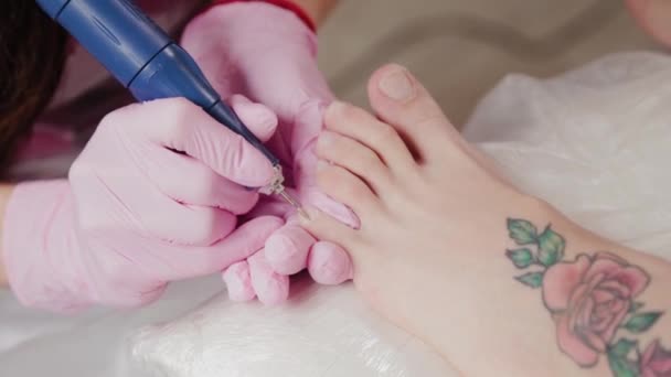 Pedicure master sawing toenails of a woman. - Footage, Video