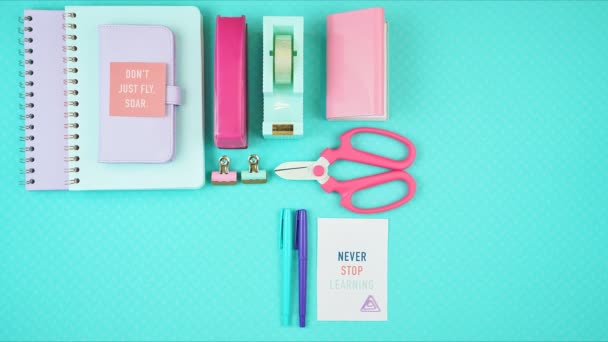 Back to school or workspace colorful stationery overhead flatlay stop motion. - Footage, Video