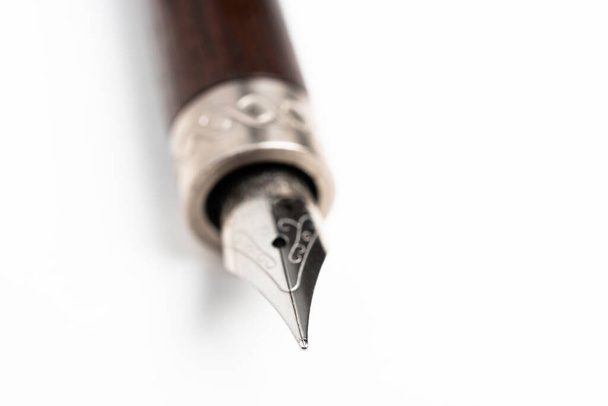 Un primo piano colpo di prodotto della canna di legno e la punta di scrittura di una penna stilografica classica impostata su sfondo bianco chiaro
. - Foto, immagini