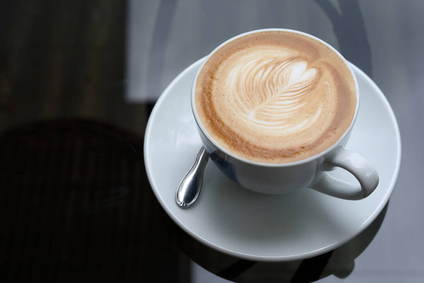 hot latte coffee drink put on table in cafe - Fotó, kép
