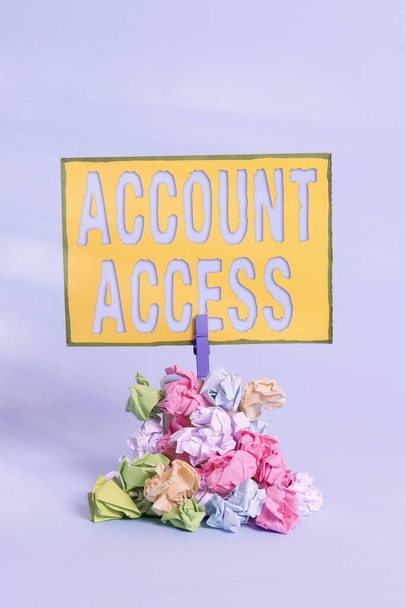 Text sign showing Account Access. Conceptual photo full privilege for the owners to manage their an individualal data Reminder pile colored crumpled paper clothespin reminder blue background. - Photo, Image