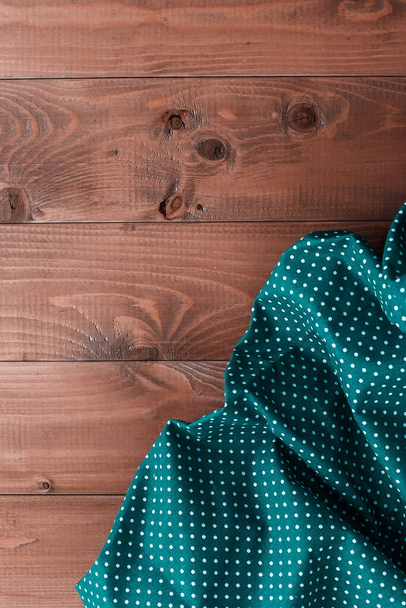Checkered napkin on wooden background. kitchen textiles - Фото, изображение