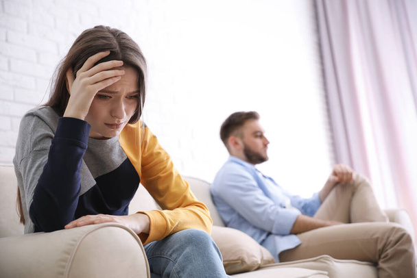 Unhappy couple with problems in relationship at home, focus on woman - Foto, afbeelding