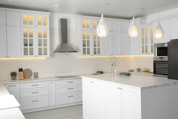 Beautiful kitchen interior with new stylish furniture - Фото, изображение