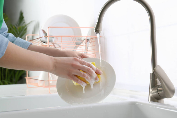 Placa de lavado de mujer en la cocina moderna, primer plano - Foto, imagen