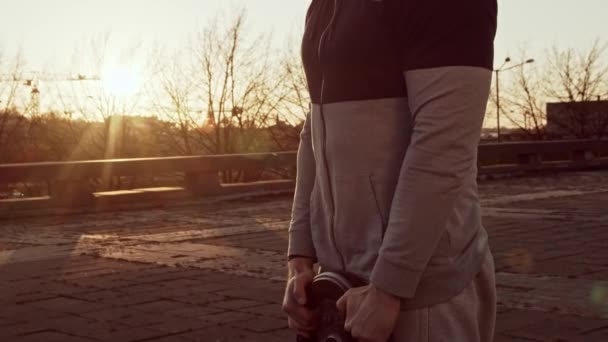 Young and fit man having evening workout outdoor. Urban sunset background. Fitness and sport concepts. - Filmagem, Vídeo