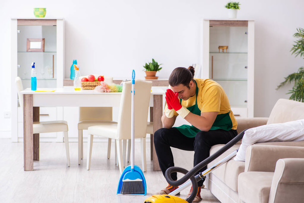 Young male contractor cleaning the house - Photo, image