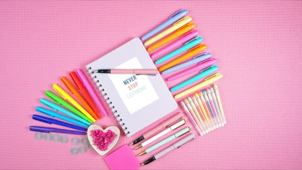 Vissza az iskolába vagy a munkahelyre színes írószer rózsaszín lapos stop motion. - Felvétel, videó