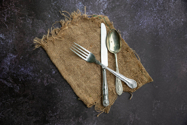 Flat lay image of vintage cutlery on textured rough background - Photo, Image