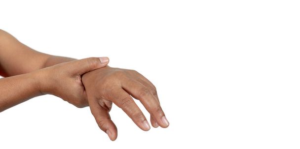 De hand van een persoon met pijn in de pols op een witte achtergrond, Het concept van ziekte van hard werken. - Foto, afbeelding