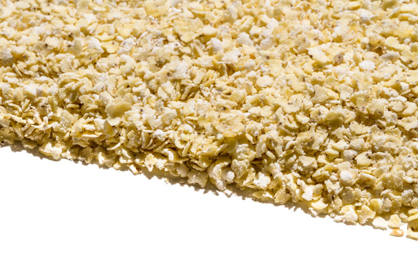 Close up. Dry, raw  yellow millet flakes frame on white background - Fotó, kép